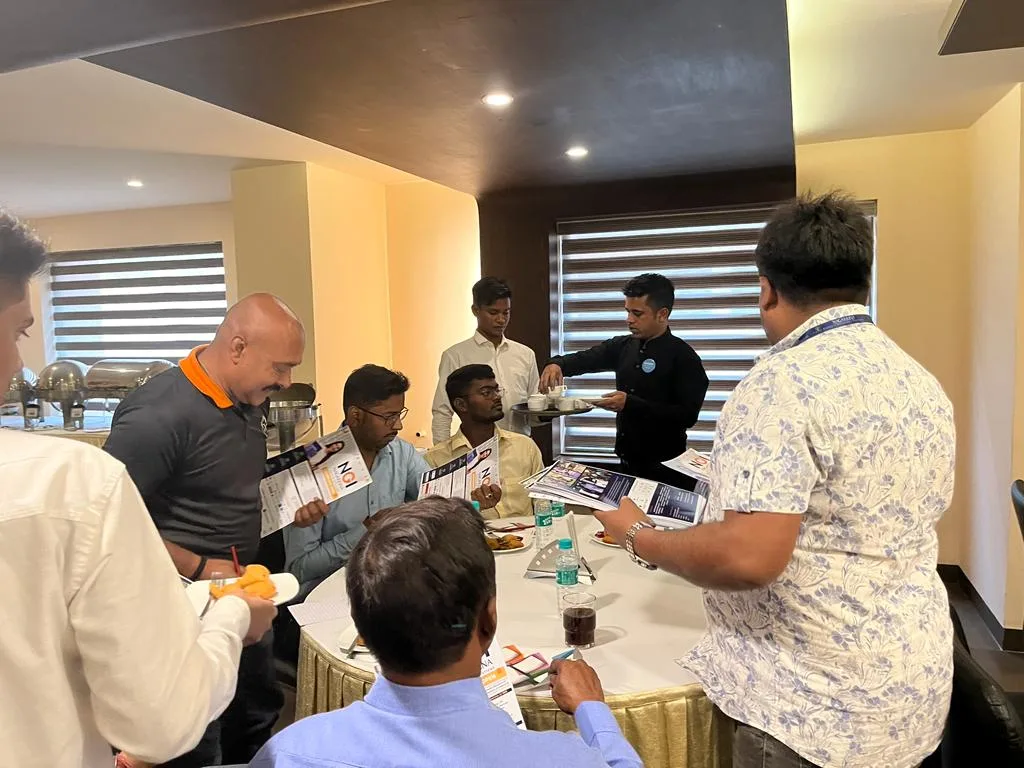 Participants sharing printed information during an educators gathering