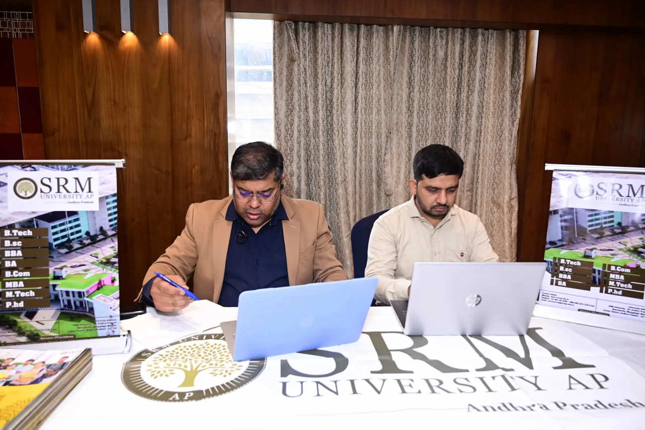 Representatives seated at an SRM University AP information desk