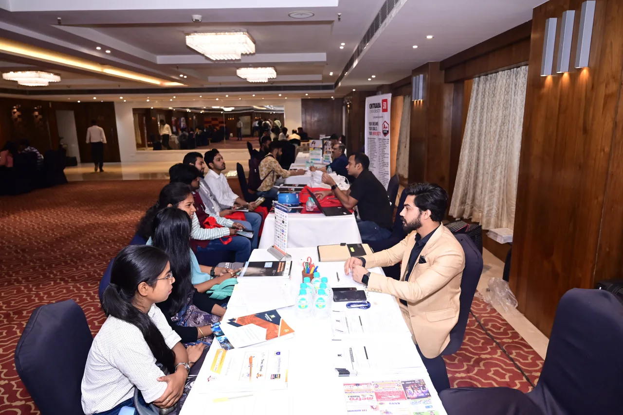 Students and education representatives meeting across a row of counselling desks